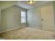 Bedroom with neutral carpet, large window, and white painted door at 2683 Mariner Way, Villa Rica, GA 30180
