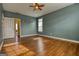 Bedroom featuring hardwood floors, access to ensuite bathroom, and a ceiling fan at 2683 Mariner Way, Villa Rica, GA 30180