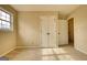 Bedroom with a large window, double door closet, and neutral carpeting at 2683 Mariner Way, Villa Rica, GA 30180