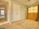 Bedroom with neutral carpet, and a double closet door with neutral-colored walls at 2683 Mariner Way, Villa Rica, GA 30180