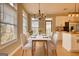 Dining room features natural light, modern lighting, and adjacent kitchen with stainless appliances at 2683 Mariner Way, Villa Rica, GA 30180