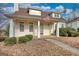 Inviting two-story home with front porch, decorative columns, and meticulously maintained landscaping at 2683 Mariner Way, Villa Rica, GA 30180