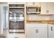 This kitchen features stainless steel appliances, double ovens, and white cabinets at 2683 Mariner Way, Villa Rica, GA 30180