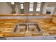 Close-up of kitchen sink with hardwood counters, stairs, front door and fireplace in view at 2683 Mariner Way, Villa Rica, GA 30180