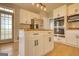 Modern kitchen island boasts stainless steel appliances, white cabinets, and hardwood floors at 2683 Mariner Way, Villa Rica, GA 30180