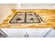 Close-up of gas range with stainless steel cooktop and wood counters at 2683 Mariner Way, Villa Rica, GA 30180