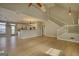 Open-concept living area showcasing hardwood floors, staircase, and kitchen area, great for entertaining at 2683 Mariner Way, Villa Rica, GA 30180
