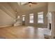 Inviting living room with vaulted ceiling, hardwood floors, and ample natural light from large windows at 2683 Mariner Way, Villa Rica, GA 30180