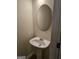 Bathroom with sink and an oval mirror above pedestal sink at 2764 Keystone Ave, Lithonia, GA 30058