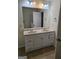 Bathroom featuring double vanity with white cabinets and a large mirror at 2764 Keystone Ave, Lithonia, GA 30058