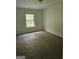 This carpeted bedroom has a window letting in natural light at 2764 Keystone Ave, Lithonia, GA 30058