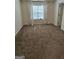 Spacious bedroom with a large window and neutral carpeting at 2764 Keystone Ave, Lithonia, GA 30058