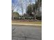 The property clubhouse provides various amenities for residents, with mature trees and black metal fence at 2764 Keystone Ave, Lithonia, GA 30058
