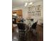 Bright dining area featuring a glass table with seating, chandelier, and wall art adjacent to the well-equipped kitchen at 2764 Keystone Ave, Lithonia, GA 30058