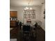 Inviting dining room features a glass table, stylish chandelier, and elegant butterfly artwork at 2764 Keystone Ave, Lithonia, GA 30058