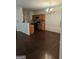 Open-concept dining area featuring wood flooring, a chandelier, and modern appliances at 2764 Keystone Ave, Lithonia, GA 30058