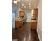 Open kitchen layout with wood cabinetry, modern appliances, and dark hardwood flooring at 2764 Keystone Ave, Lithonia, GA 30058
