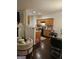 Open-concept kitchen and living area with modern appliances, wood cabinets, and a comfortable seating arrangement at 2764 Keystone Ave, Lithonia, GA 30058