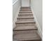 View of carpeted staircase with white risers, offering a functional design element at 2764 Keystone Ave, Lithonia, GA 30058