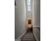 Carpeted staircase features a charming window, handrail, and a decorative mirror, creating an inviting path to the next level at 2764 Keystone Ave, Lithonia, GA 30058