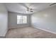 Bright bedroom featuring neutral walls, a ceiling fan, and a large window for natural light at 976 Buckhorn Bnd, Locust Grove, GA 30248