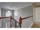 Staircase with hard wood banister, white railings, and view of the foyer at 976 Buckhorn Bnd, Locust Grove, GA 30248