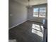 Dining area adjacent to kitchen featuring gray walls, modern flooring, and a contemporary chandelier at 480 Pine Pl, Riverdale, GA 30274