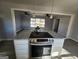 Kitchen island with stainless steel stove and granite countertops ready for cooking and entertaining at 480 Pine Pl, Riverdale, GA 30274