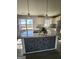 Kitchen island featuring granite countertops, modern tile base and stainless steel appliances at 480 Pine Pl, Riverdale, GA 30274