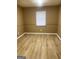 A bedroom featuring a large window and contemporary wood flooring at 2400 Reynolds Sw Rd, South Fulton, GA 30331