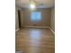 A bedroom with a window and modern wood-style floors at 2400 Reynolds Sw Rd, South Fulton, GA 30331