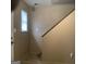 Hallway and staircase with neutral walls and flooring, providing a blank canvas for personalization at 2400 Reynolds Sw Rd, South Fulton, GA 30331