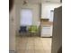 Bright kitchen area with white cabinets, tile floors and natural light from the window at 2400 Reynolds Sw Rd, South Fulton, GA 30331