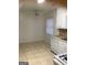 Bright kitchen and dining area with tile floors, white appliances, and a ceiling fan at 2400 Reynolds Sw Rd, South Fulton, GA 30331