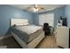 A comfortable bedroom is painted blue with a fan overhead at 306 Oakwind Way, Canton, GA 30114