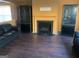 Cozy living room featuring a fireplace flanked by black display cabinets and hardwood floors at 5620 Sable Way, Atlanta, GA 30349