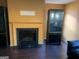 Living room featuring a fireplace, black cabinets, and hardwood floors at 5620 Sable Way, Atlanta, GA 30349