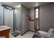 Bathroom features a shower, marble-look sink, and window at 613 Rock Springs Pass, Dallas, GA 30157