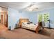 Light blue bedroom features a ceiling fan and a window with a wooded view at 613 Rock Springs Pass, Dallas, GA 30157