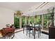 Bright dining room with large windows overlooking a wooded area and a unique table at 613 Rock Springs Pass, Dallas, GA 30157