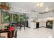 Open kitchen and dining area with white tile floors and wooded view from the windows at 613 Rock Springs Pass, Dallas, GA 30157