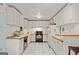 Kitchen featuring white cabinets, a black stove, and checkered tile flooring at 613 Rock Springs Pass, Dallas, GA 30157