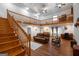 Spacious living room with wood floors, high ceilings, and a staircase leading to an upstairs loft at 613 Rock Springs Pass, Dallas, GA 30157