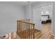 View of the staircase and the main bedroom; featuring wood floors and white walls at 13789 Woolsey Rd, Hampton, GA 30228