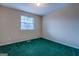 Cozy bedroom featuring a window for natural light and comfortable green carpeting at 787 N Ola Rd, Mcdonough, GA 30252