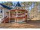 Close up view of turret and porch with red railings on house with vinyl siding at 787 N Ola Rd, Mcdonough, GA 30252