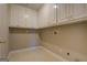 Efficient laundry area with ample storage cabinets above the washer and dryer hookups at 787 N Ola Rd, Mcdonough, GA 30252