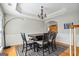 Cozy dining area with wood floors, wainscoting, modern light fixture and comfortable seating for four at 405 Linkmere Ln, Covington, GA 30014