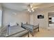 Bright bedroom with twin beds, ceiling fan and window provides a cozy and functional living space at 925 Whitehawk Trl, Lawrenceville, GA 30043