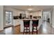 Well-lit kitchen area showcases stainless steel appliances, granite counters, and center island with barstools at 925 Whitehawk Trl, Lawrenceville, GA 30043